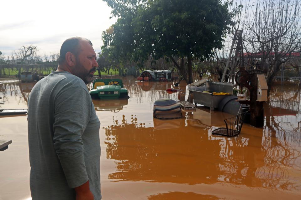 Ubaldo Sanchez, who likes to go by Lalo, surveys the damage his family's property saw following an intense series of storms since Dec. 26. It wasn't until this week that the area flooded, taking cars and other farming equipment out over the span of just a few hours.