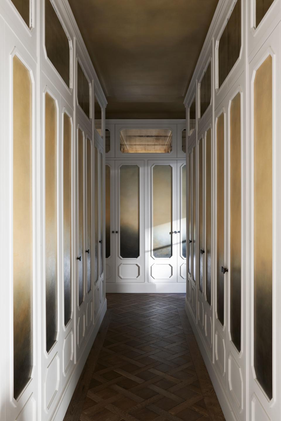 Mirrored and painted panels line a hallway.