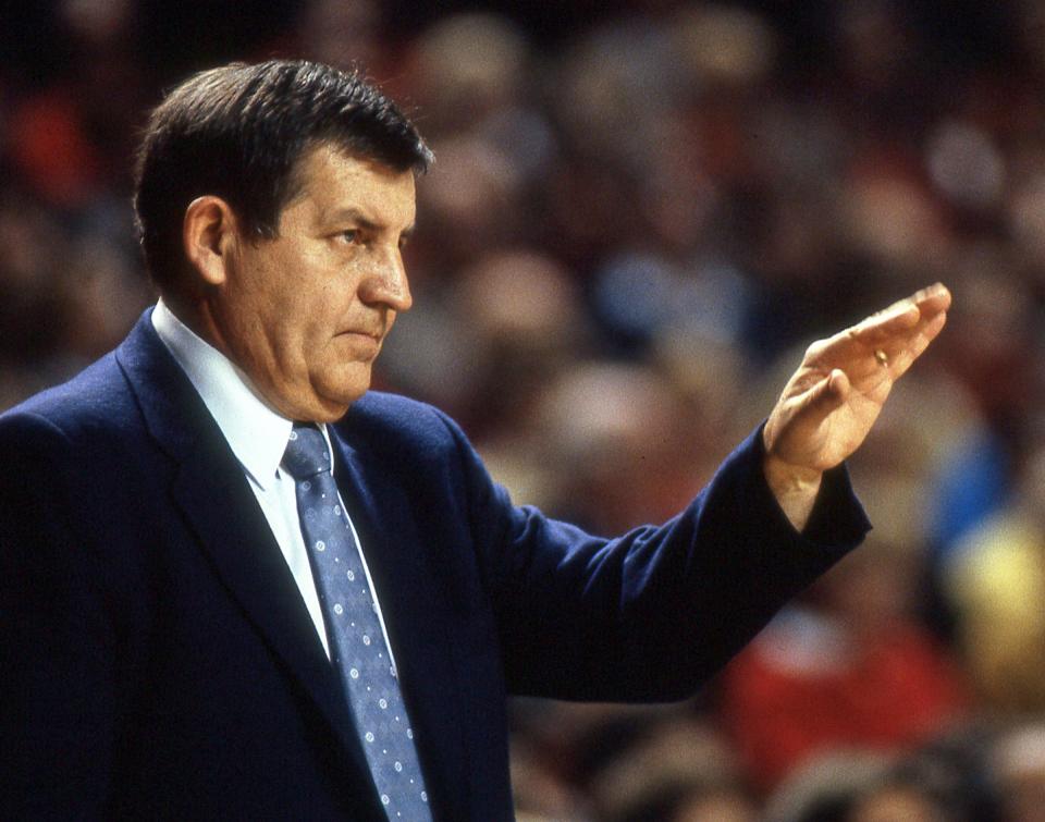 Louisville men's basketball assistant coach Jerry Jones stands on the sideline during a game. Jones died Monday at age 89.