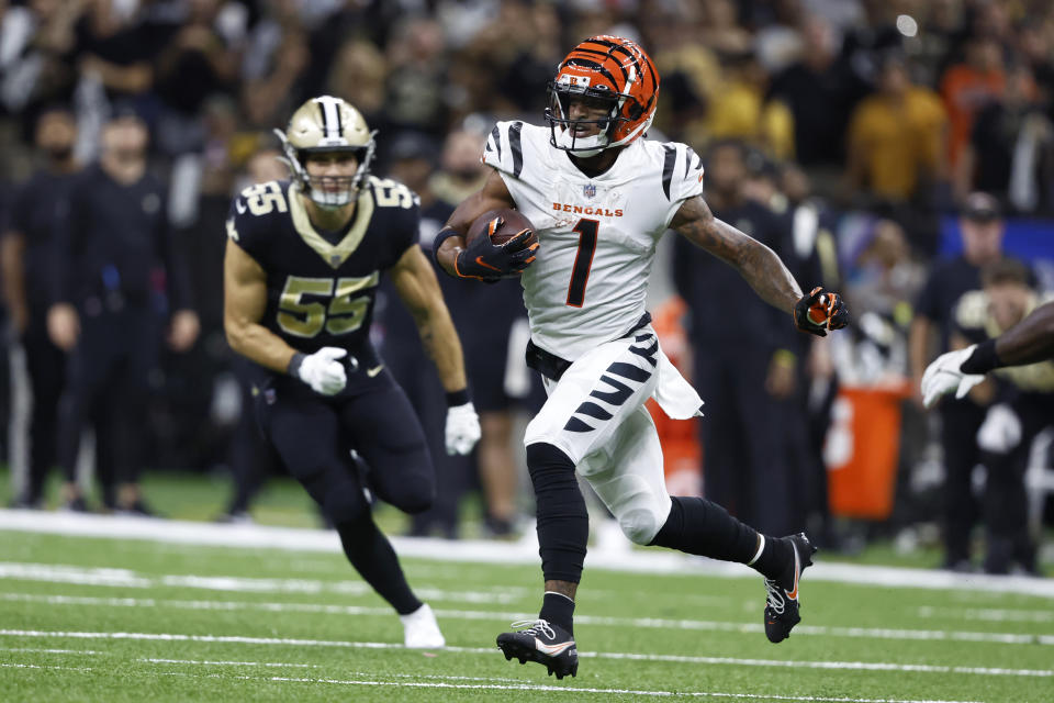 Cincinnati Bengals wide receiver Ja'Marr Chase (1) runs past New Orleans Saints linebacker Kaden Elliss (55) during the second half of an NFL football game in New Orleans, Sunday, Oct. 16, 2022. (AP Photo/Butch Dill)