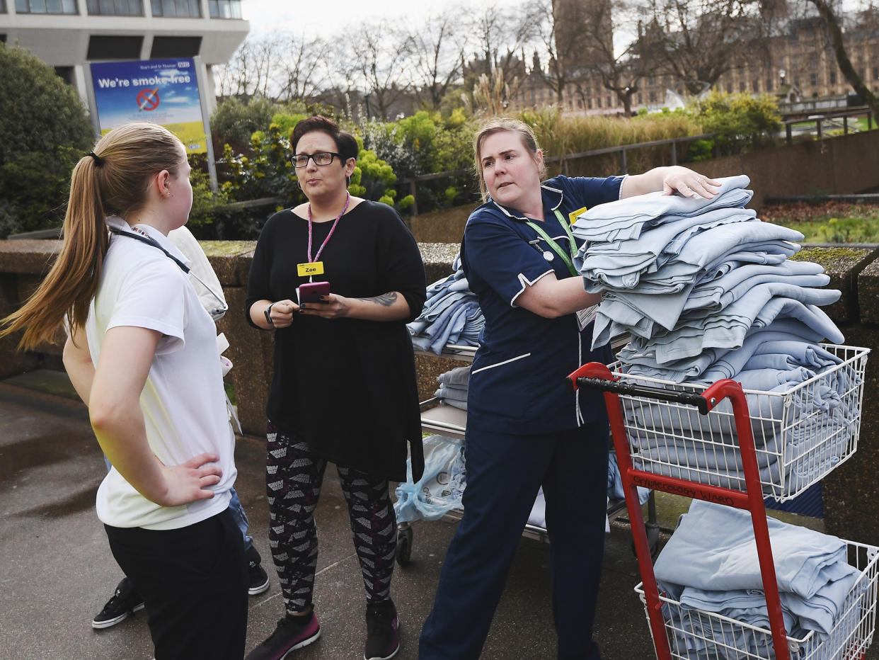 Nurses from St Thomas' hospital load blankets outside the hospital after a terrorist attack in Westminster: Getty Images