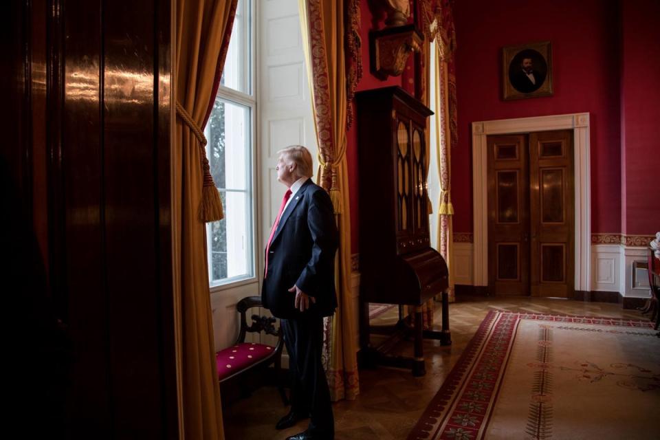 Post the traditional inaugural tea and coffee reception, President Donald Trump looks out of the Red Room window onto the South Portico of the White House grounds on Friday, Jan. 20 2017 prior to departing the White House for the Presidential Inaugural ceremony.&nbsp;