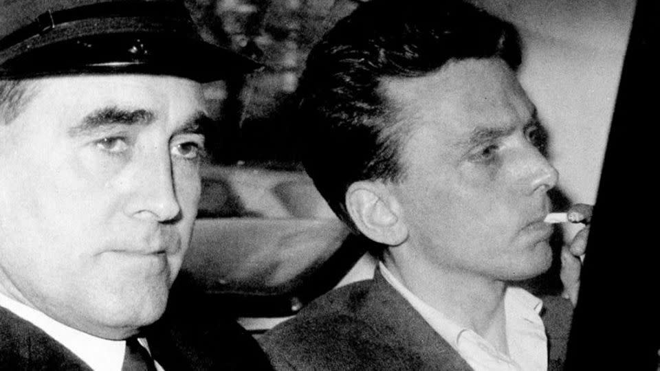 In this file photo dated Oct. 1965, Ian Brady, right, is escorted as he arrives at the courthouse in Hyde, Cheshire, England, to be convicted of the Moors murders of five children together with accomplice Myra Hindley in the Greater Manchester area of England. Source: Yahoo UK