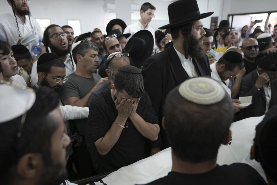 Jewish mourners gather in Petah Tikva, Israel at the funeral for Yonatan Havakuk, the day after he was killed with two others in a stabbing attack in Elad, Friday, May 6, 2022. Israeli security forces waged a massive manhunt Friday for two Palestinians suspected of carrying out the stabbing attack on Thursday near Tel Aviv that left three Israelis dead.(AP Photo/Ariel Schalit)