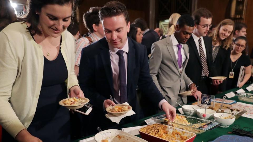 In this pre-pandemic photo, congressional staffers sample entries in an annual hot-dish competition in the Dirksen Senate Office Building on Capitol Hill in Washington, D.C. (Photo by Chip Somodevilla/Getty Images)