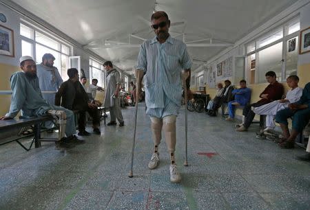 Mohammad Zaman, an Afghan local policeman who was wounded in Daikundi province, walks with his prosthetic legs at the International Committee of the Red Cross (ICRC) orthopaedic rehabilitation centre in Kabul August 26, 2014. REUTERS/Omar Sobhani