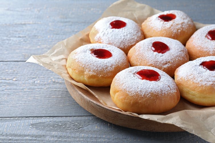 A plate of donuts with jam centres.