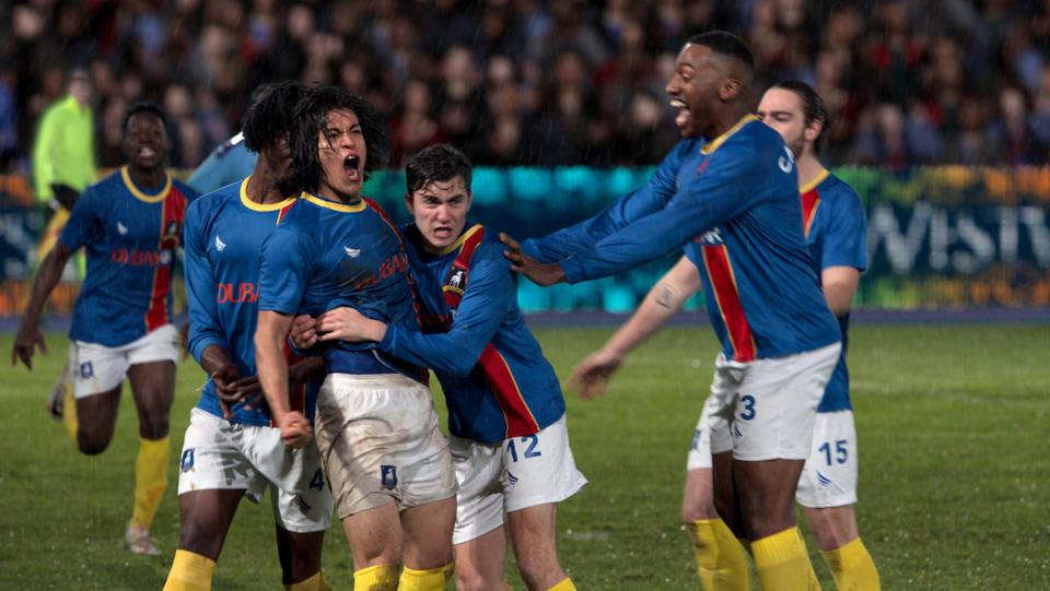 A group of soccer players celebrate in Ted Lasso