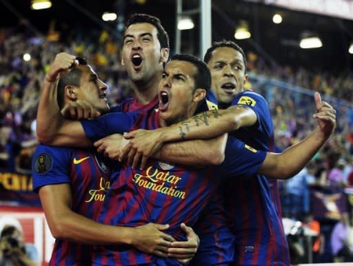 Barcelona's forward Pedro Rodriguez (C) celebrates with his teammates after scoring during the Spanish King's Cup final against Athletic Bilbao at the Vicente Calderon stadium in Madrid. Barcelona won 3-0