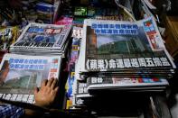 Copies of the Apple Daily newspaper are seen at a newspaper stall after it looked set to close for good by Saturday following police raids and the arrest of executives in Hong Kong