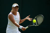 LONDON, ENGLAND - JUNE 28: Aleksandra Wozniak of Canada hits a backhand return during her Ladies' Singles second round match against Jie Zheng of China on day four of the Wimbledon Lawn Tennis Championships at the All England Lawn Tennis and Croquet Club on June 28, 2012 in London, England. (Photo by Clive Brunskill/Getty Images)