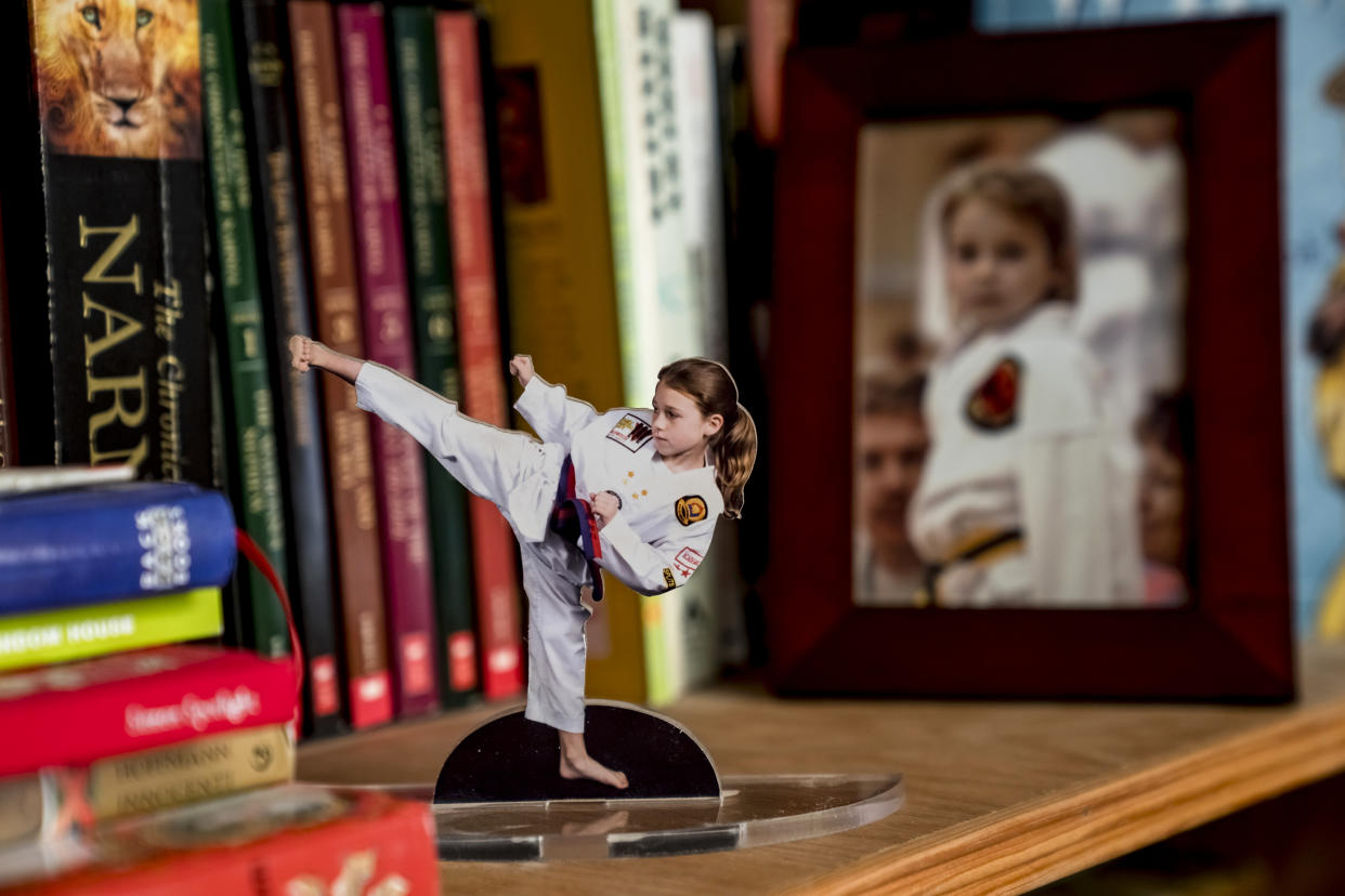 Photos of MacKenzie Loesch as a child are displayed on a bookshelf at her home in Marthasville, Mo. (Whitney Curtis for NBC News)