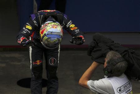 Sebastian Vettel of Germany bows as he celebrates winning the Brazilian F1 Grand Prix at the Interlagos circuit in Sao Paulo