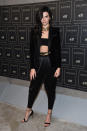 <p>Jenner proved just how expensive Balmain’s (mostly) affordable H&M collaboration can look at the collection’s Downtown launch party. In lieu of a skin tight, bedazzled dress, the model channeled the ‘80s with her outfit—wearing a structured black blazer, satin-y harem pants with gold detailing at the waist, and an understated boob tube. To escalate the pieces further, she added a wide gold choker and minimalist black heeled sandals. </p>