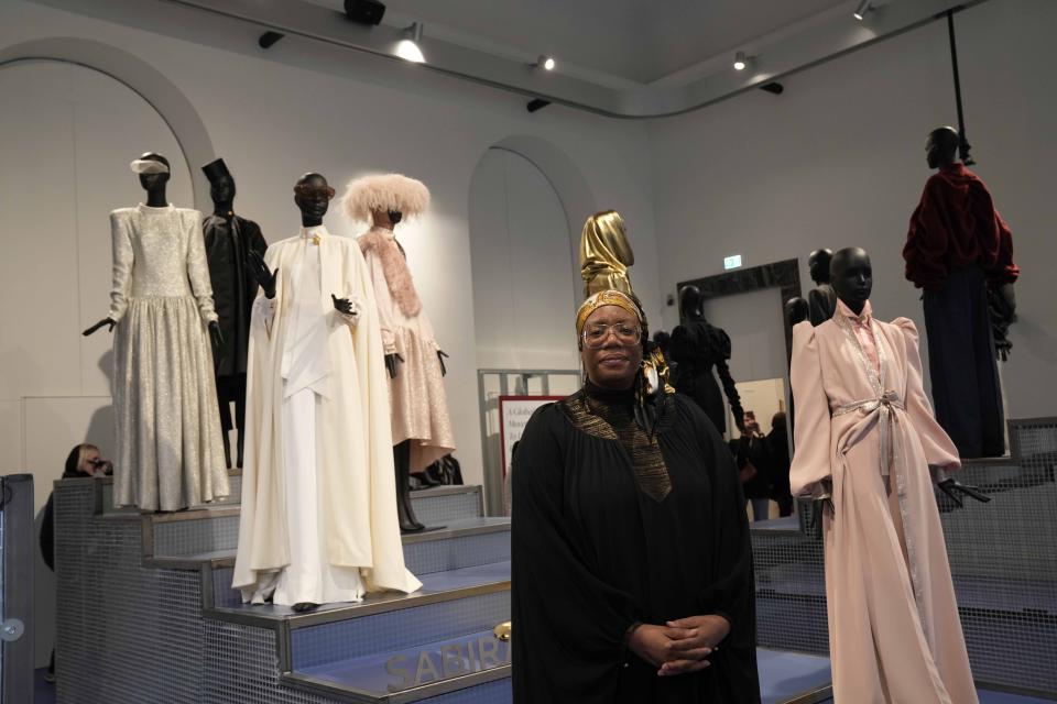 Designer Deborah Latouche poses in front of her creations Saribah at the fashion hub part of the women's Fall-Winter 2024-25 collection presented in Milan, northern Italy, Wednesday, Feb. 21, 2024. (AP Photo/Antonio Calanni)