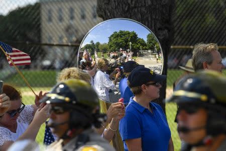 Aug 12, 2018; Annapolis, MD, USA; People watch the passing of John McCain's motorcade on his way to be laid to rest at the U.S. Naval Academy. Mandatory Credit: Jasper Colt via USA TODAY NETWORK