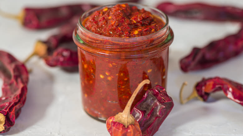 Harissa paste in jar with dried whole chilis