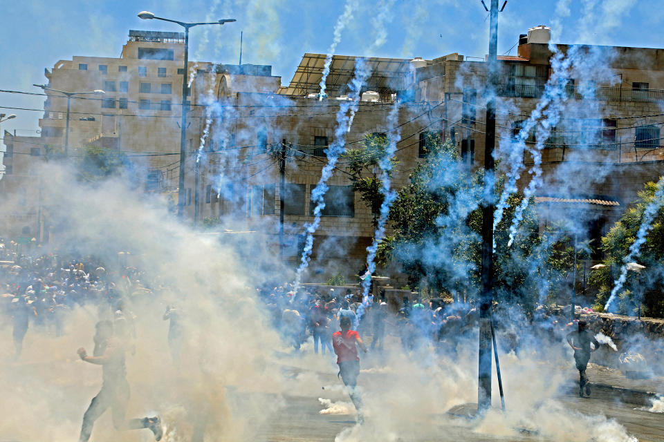 Israeli troops fire tear gas towards demonstrators during a protest against Israeli occupation in the West Bank on May 18.<span class="copyright">AFP/Getty Images</span>