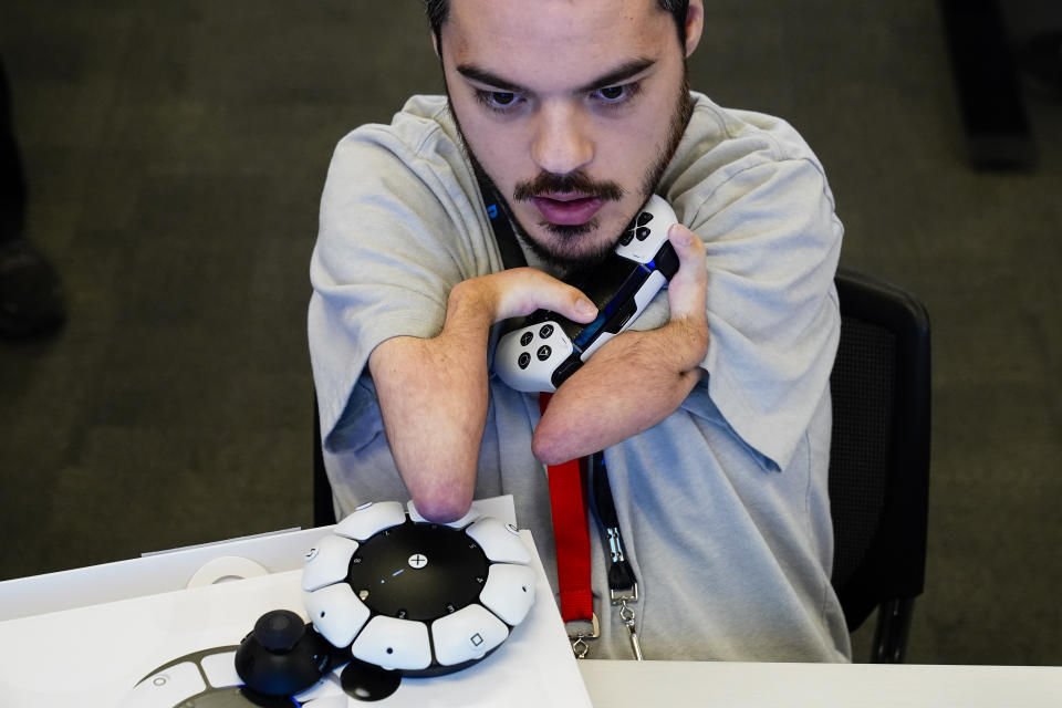 Martin Shane uses a Sony Access controller, left, to play a video game at Sony Interactive Entertainment headquarters Thursday, Sept. 28, 2023, in San Mateo, Calif. (AP Photo/Godofredo A. Vásquez)