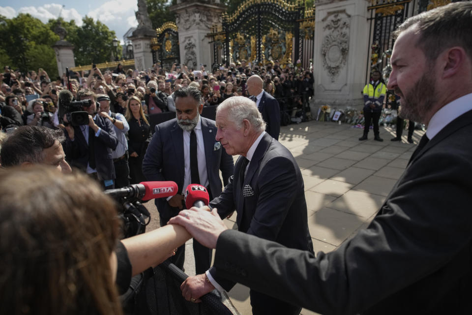 FILE - King Charles III answers questions from the media after greeting mourners outside Buckingham Palace in London, Friday, Sept. 9, 2022. Plans by news organizations that have been in place for years — even decades — to cover the death of Queen Elizabeth II were triggered and tested when the event took place. London has been inundated with journalists, with more headed to the city for the funeral services on Monday. (AP Photo/Christophe Ena, File)