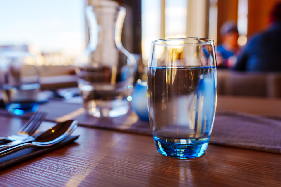 A glass of water on a table.