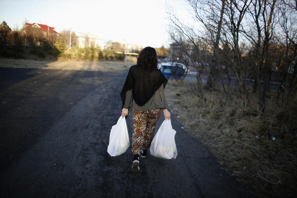 A woman carries bags with food from the Family Help project in Reykjavik February 13, 2013. Iceland's biggest IT company CCP is what the island needs to leave its economic crisis behind. It is global, growing and employs hundreds but its tale is also one of frustration that echoes concerns about the country's future. Many expected Iceland's recovery to be stronger given the way smaller economies can bounce from deep recessions. The International Monetary Fund had originally forecast annual growth of around 4.5 percent from 2011-2013. It now is under half that. Picture taken February 13, 2013. To match Analysis ICELAND-ECONOMY/                REUTERS/Stoyan Nenov (ICELAND - Tags: BUSINESS EMPLOYMENT SOCIETY SCIENCE TECHNOLOGY FOOD)