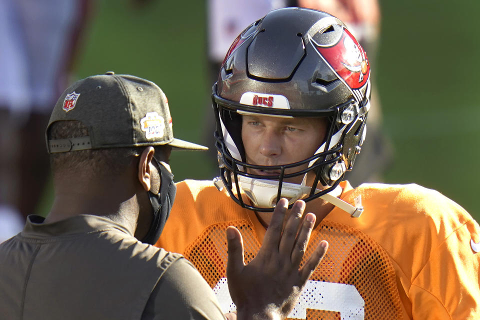 Tampa Bay Buccaneers quarterback Tom Brady talks to offensive coordinator Byron Leftwich during an NFL football training camp practice Friday, Aug. 28, 2020, in Tampa, Fla. (AP Photo/Chris O'Meara)