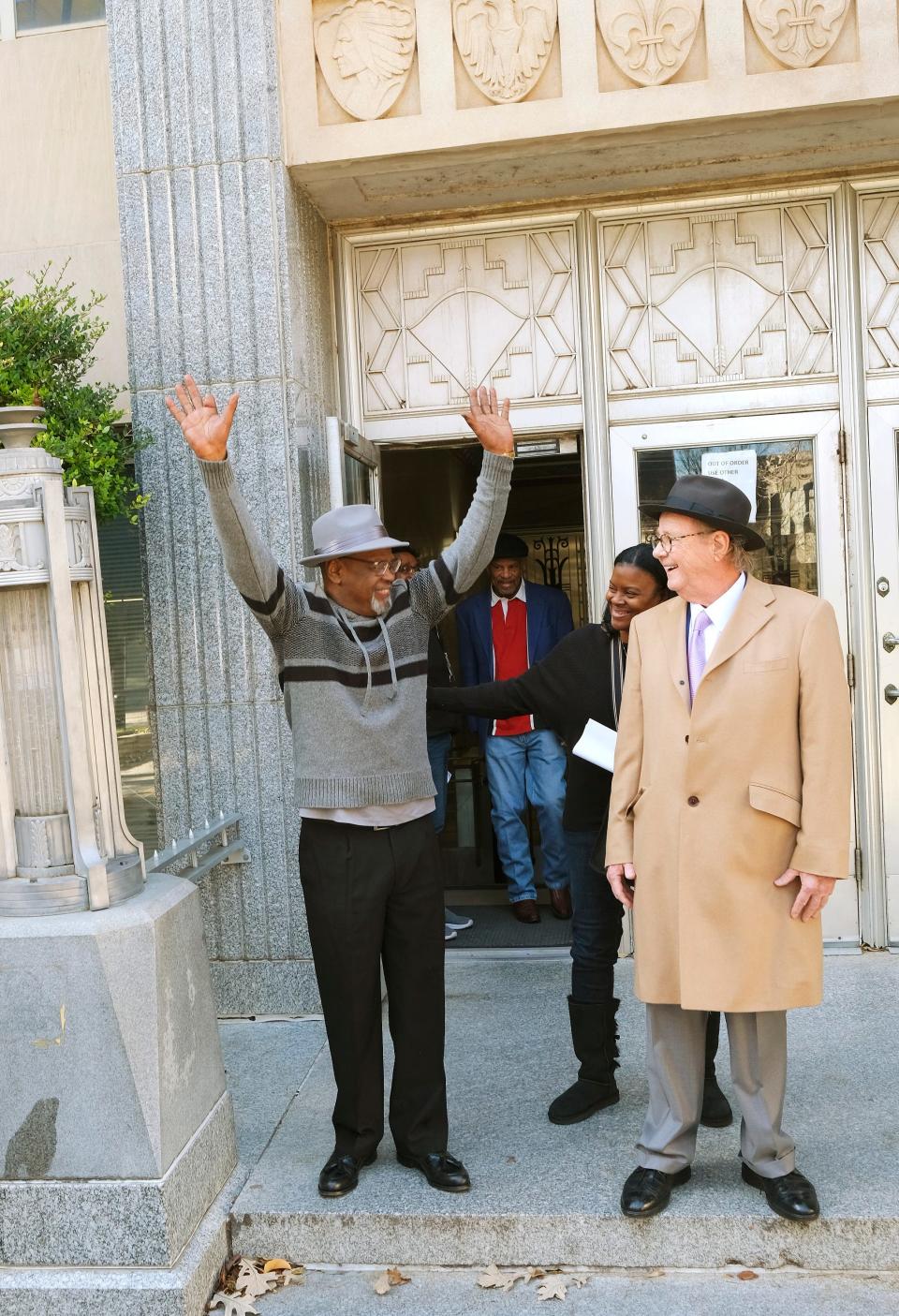 Glynn Simmons reacts after stepping out of the Oklahoma County Courthouse on Dec. 19 after Judge Amy Palumbo ruled to approve Simmons' "actual innocence" claim during a hearing. To his side is one of his lawyers, John Coyle, and his cousin, Cecilia Hawthorne.