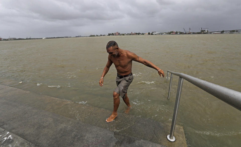 Ray Leon walks up steps after swimming in the Mississippi River, Friday, July 12, 2019, in New Orleans, ahead of Tropical Storm Barry. Barry could harm the Gulf Coast environment in a number of ways. But scientists say it’s hard to predict how severe the damage will be. (AP Photo/David J. Phillip)