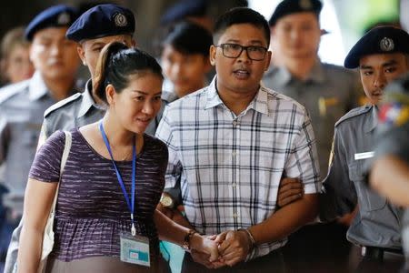 Detained Reuters journalist Wa Lone walks with his wife Pen ei mon as he arrives at Insein court in Yangon, Myanmar July 16, 2018. REUTERS/Ann Wang