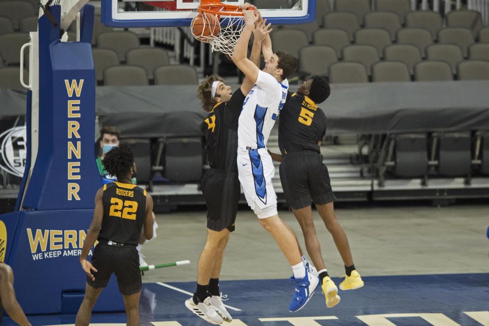 Creighton's Ryan Kalkbrenner scores against Kennesaw State's Cole LaRue, left, and Brandon Stroud during the first half of an NCAA college basketball game in Omaha, Neb., Friday, Dec. 4, 2020. (AP Photo/Kayla Wolf)