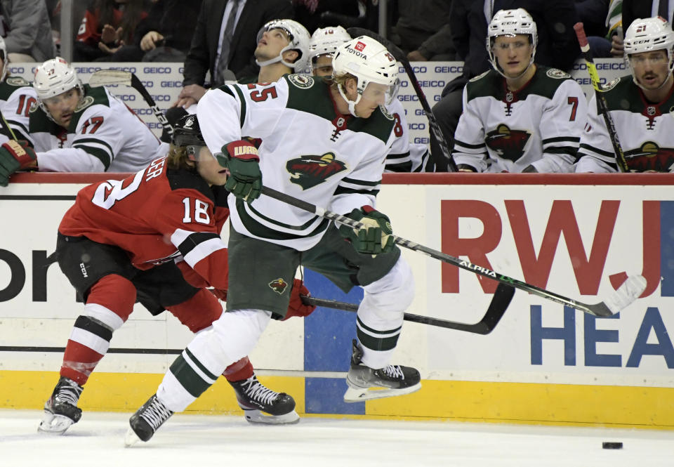 Minnesota Wild defenseman Jonas Brodin (25) beats New Jersey Devils center Dawson Mercer (18) to the puck during the second period of an NHL hockey game Wednesday, Nov.24, 2021, in Newark, N.J. (AP Photo/Bill Kostroun)