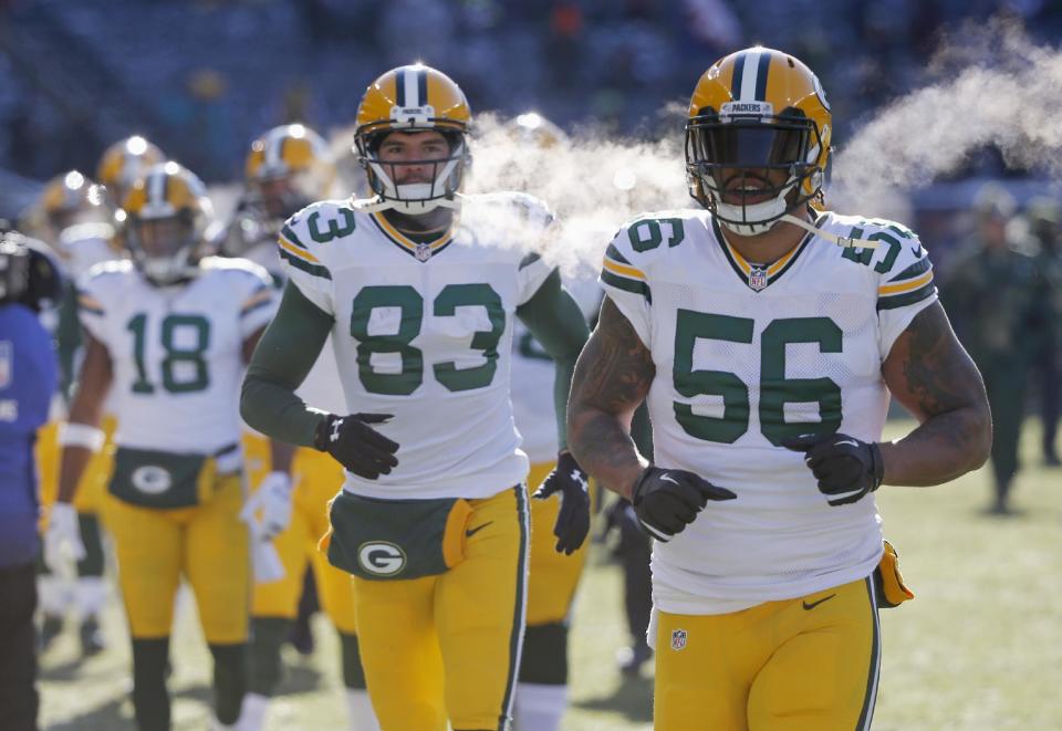Green Bay Packers linebacker Julius Peppers (56) and receiver Jeff Janis (83) run back to the locker room after warmups before an NFL football game against the Chicago Bears, Sunday, Dec. 18, 2016, in Chicago. (AP Photo/Charles Rex Arbogast)