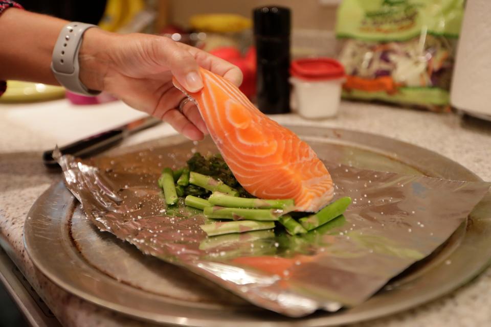 For breast cancer awareness month, Anna Jones prepared salmon and asparagus foil packets and red cabbage and apple slaw.