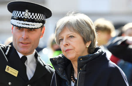 FILE PHOTO: Britain's Prime Minister Theresa May visits the city where former Russian intelligence officer Sergei Skripal and his daughter Yulia were poisoned with a nerve agent, in Salisbury, Britain March 15, 2018. REUTERS/Toby Melville/Pool/File Photo