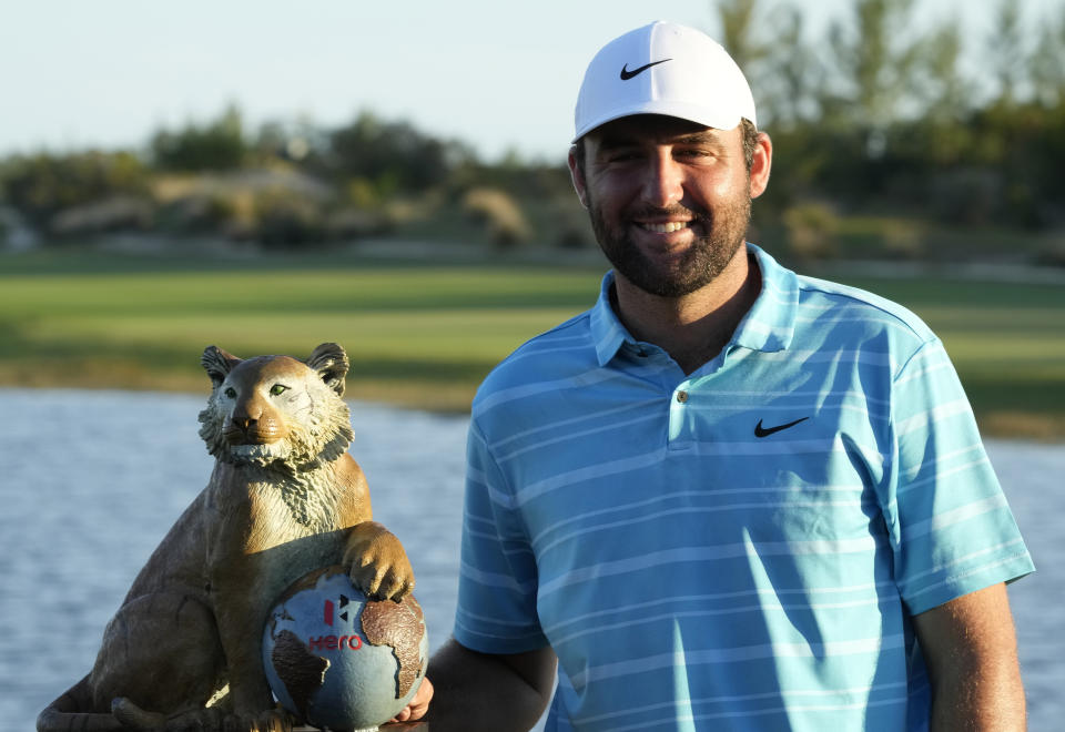 Scottie Scheffler, of the United States, poses with the winner's trophy after his victory in the Hero World Challenge PGA Tour at the Albany Golf Club in New Providence, Bahamas, Sunday, Dec. 3, 2023. (AP Photo/Fernando Llano)