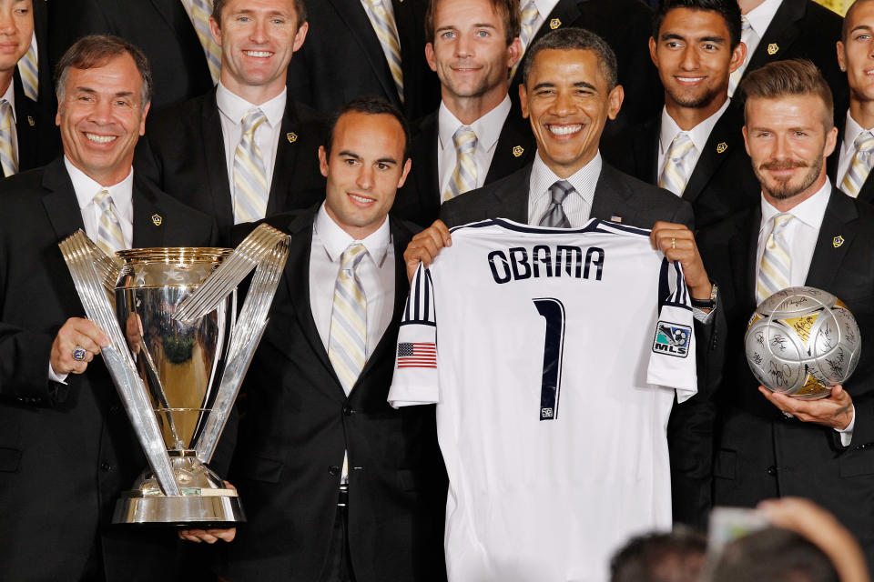 WASHINGTON, DC - MAY 15: U.S. President Barack Obama (2nd R) poses for photographs with the Major League Soccer champions Los Angeles Galaxy, including General Manager and Head Coach Bruce Arena (L) and mid-fielders Landon Donovan and David Beckham (R) in the East Room of the White House May 15, 2012 in Washington, DC. Players from the Galaxy also participated in a "Let's Move!" question and answer session with school-age sports fans and first lady Michelle Obama after the ceremony. (Photo by Chip Somodevilla/Getty Images)