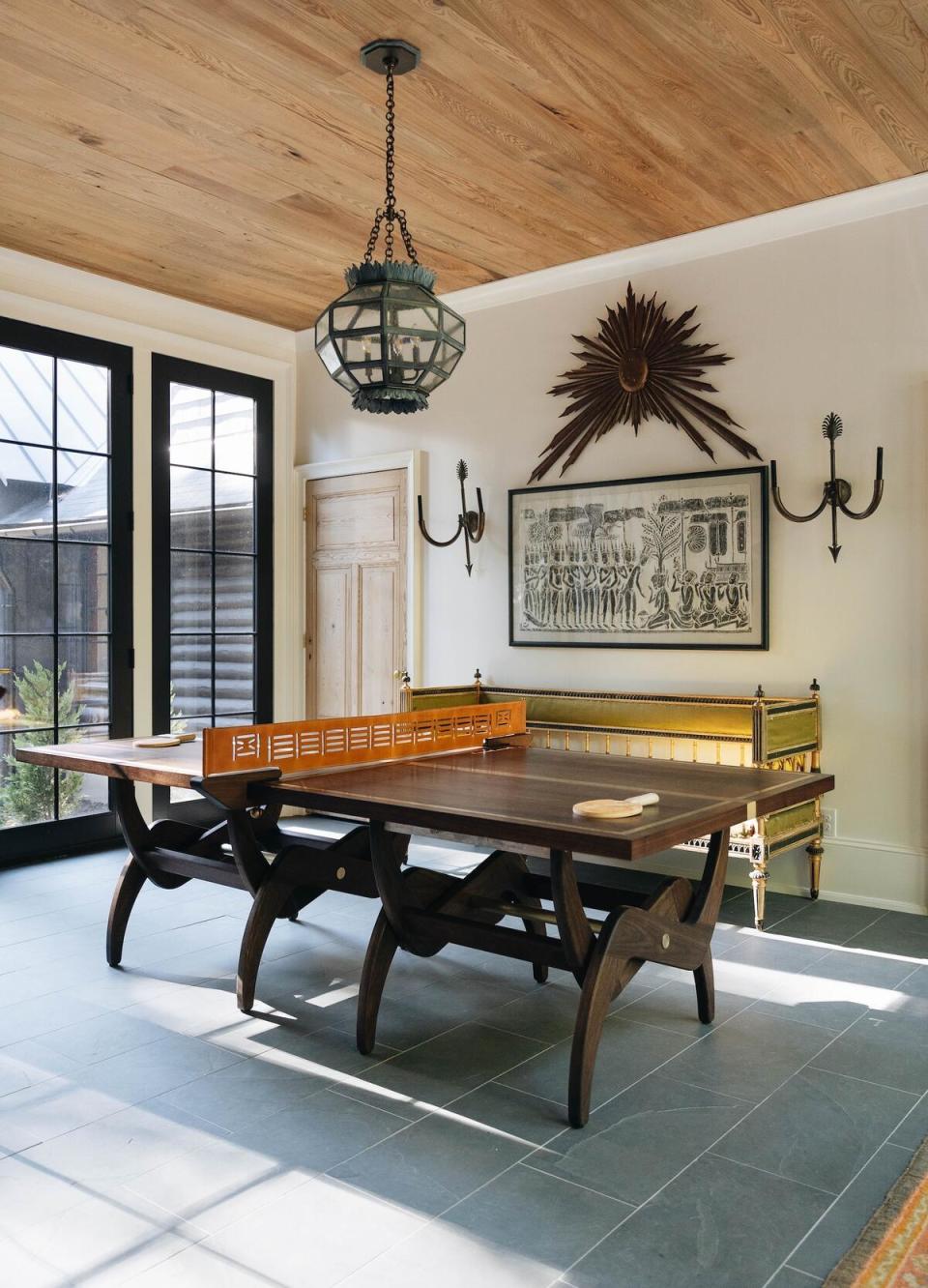 An adjustable dining/cocktail/Ping-Pong table designed by Chenault James Interiors