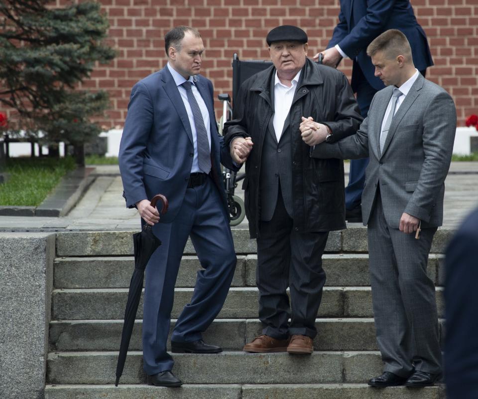 FILE - Former Soviet leader Mikhail Gorbachev, center, is helped by his assistants as he arrives to attend the Victory Day military parade to celebrate 74 years since the victory in WWII in Red Square in Moscow, Russia on Thursday, May 9, 2019. Russian news agencies are reporting that former Soviet President Mikhail Gorbachev has died at 91. The Tass, RIA Novosti and Interfax news agencies cited the Central Clinical Hospital. (AP Photo/Alexander Zemlianichenko, File)