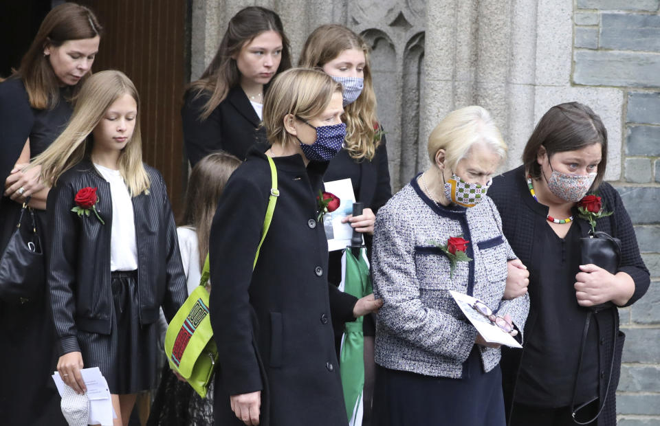 Patricia Hume, second right, and her daughter Mo follow the coffin of the former Northern Ireland lawmaker and Nobel Peace Prize winner John Hume as it is carried from funeral Mass at St Eugene's Cathedral in Londonderry, Northern Ireland, Wednesday, Aug. 5, 2020. Hume was co-recipient of the 1998 Nobel Peace Prize with fellow Northern Ireland lawmaker David Trimble, for his work in the Peace Process in Northern Ireland. Masks are worn due to the ongoing Coronavirus outbreak . (AP Photo/Peter Morrison)