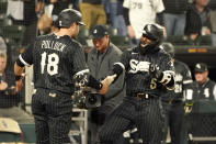 Chicago White Sox's Josh Harrison (5) and AJ Pollock celebrate Harrison's two-run home run off Minnesota Twins starting pitcher Bailey Ober during the second inning of a baseball game Monday, Oct. 3, 2022, in Chicago. (AP Photo/Charles Rex Arbogast)