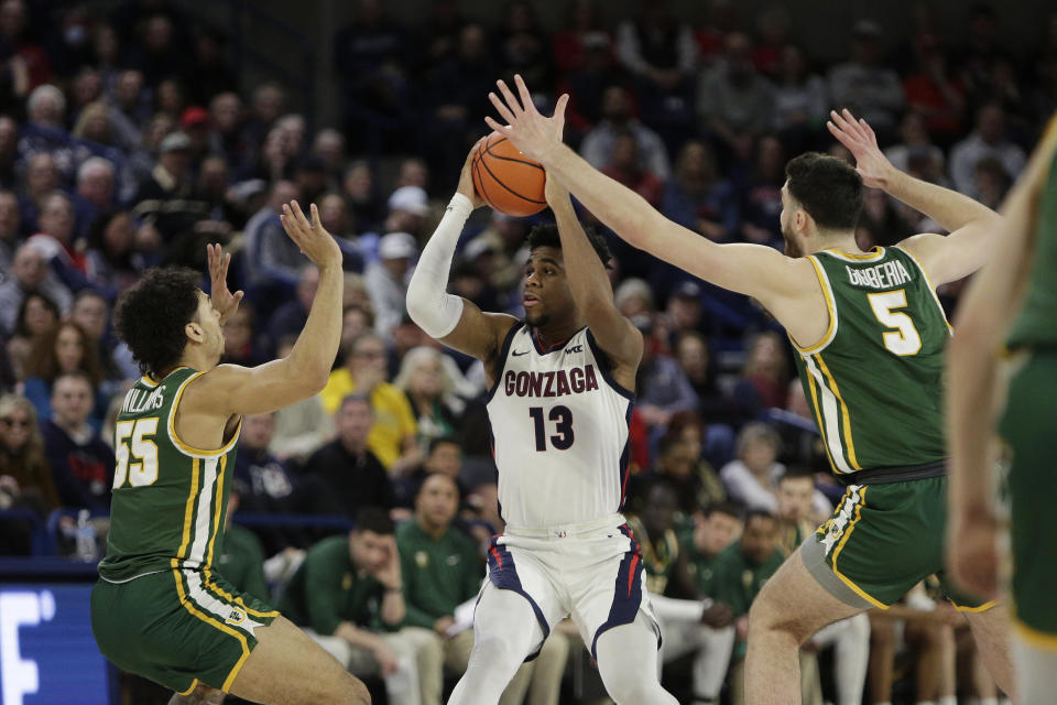 San Francisco guard Marcus Williams (55) and center Saba Gigiberia (5) double-team Gonzaga guard Malachi Smith (13) during the second half of an NCAA college basketball game, Thursday, Feb. 9, 2023, in Spokane, Wash. (AP Photo/Young Kwak)