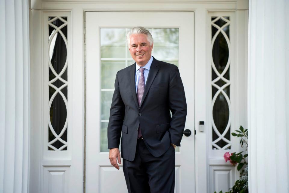 David Greene, president of Colby College, poses for a portrait on the front steps of the Osborne House on the campus in Waterville, Maine.