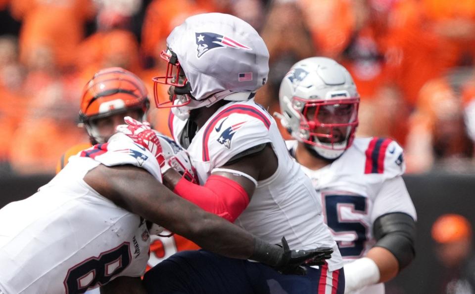 Jabrill Peppers of New England Patriots is hit by Joe Burrow of Cincinnati Bengals