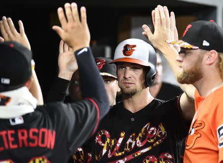 Jul 14, 2018; Baltimore, MD, USA; Baltimore Orioles catcher Caleb Joseph (36) is congratulated by teammates after scoring a run against the Texas Rangers during the sixth inning at Oriole Park at Camden Yards. Mandatory Credit: Brad Mills-USA TODAY Sports