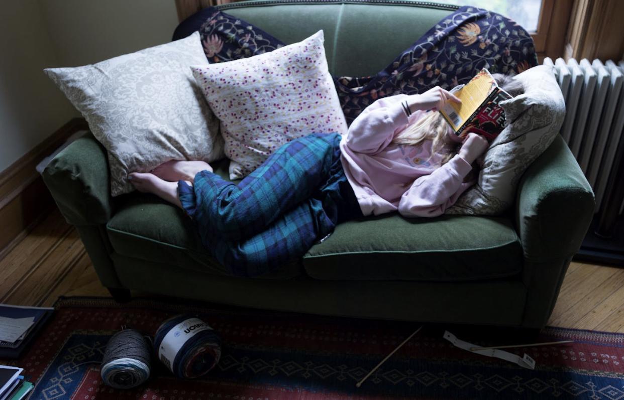 Some Gen Zers and millennials might not identify as readers because they assume the reading that they do doesn't 'count.' <a href="https://www.gettyimages.com/detail/news-photo/teenager-reads-a-school-english-assignment-at-home-after-news-photo/1216474726?adppopup=true" rel="nofollow noopener" target="_blank" data-ylk="slk:Andrew Lichtenstein/Corbis via Getty Images;elm:context_link;itc:0;sec:content-canvas" class="link ">Andrew Lichtenstein/Corbis via Getty Images</a>