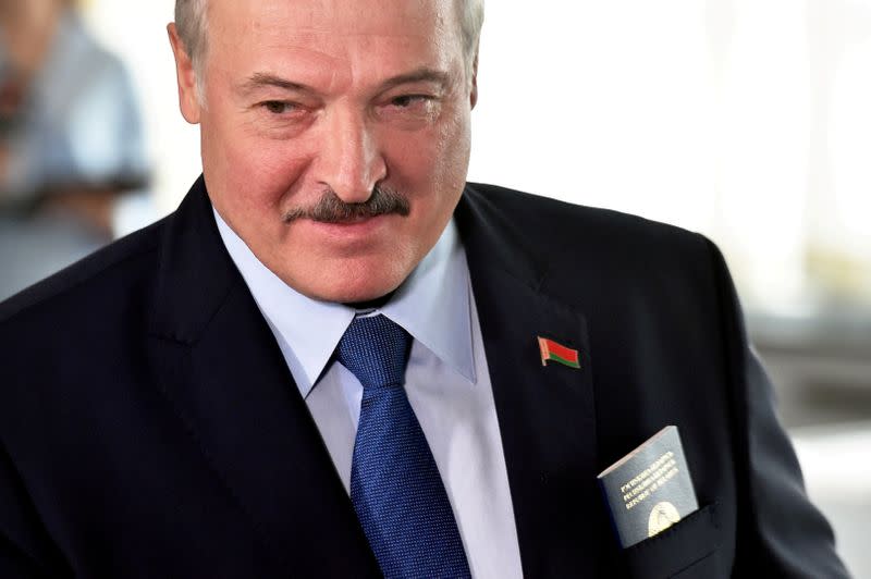 FILE PHOTO: Belarusian President Alexander Lukashenko visits a polling station during the presidential election in Minsk