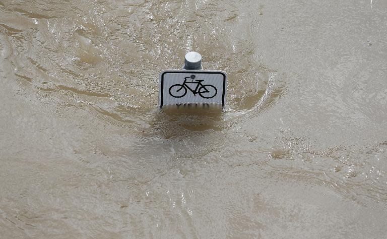 Water is seen at the top of a sign along a bike path near Memorial Drive in Houston, Texas on May 26, 2015