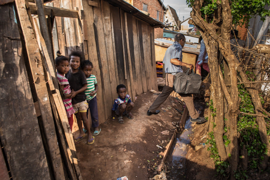 A doctor makes his way through the alleys of Antananarivo and toward the house of a plague victim. People who've been in contact with a plague case require twice-daily checkups for about a week. (Photo: Alexander Joe)
