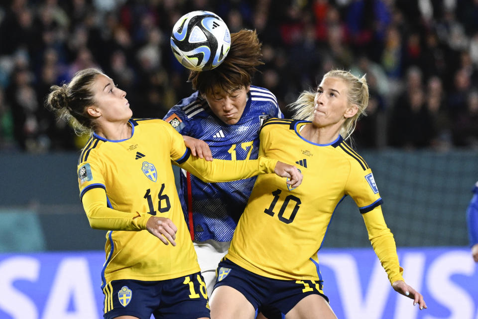 Japan's Hana Takahashi, center, attempts to head the ball as Sweden's Filippa Angeldal, left, and Sofia Jakobsson, right, compete during the Women's World Cup quarterfinal soccer match between Japan and Sweden at Eden Park in Auckland, New Zealand, Friday, Aug. 11, 2023. (AP Photo/Andrew Cornaga)